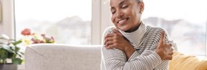 Peaceful woman holding her chest, symbolizing recovery from low self-worth and anxiet